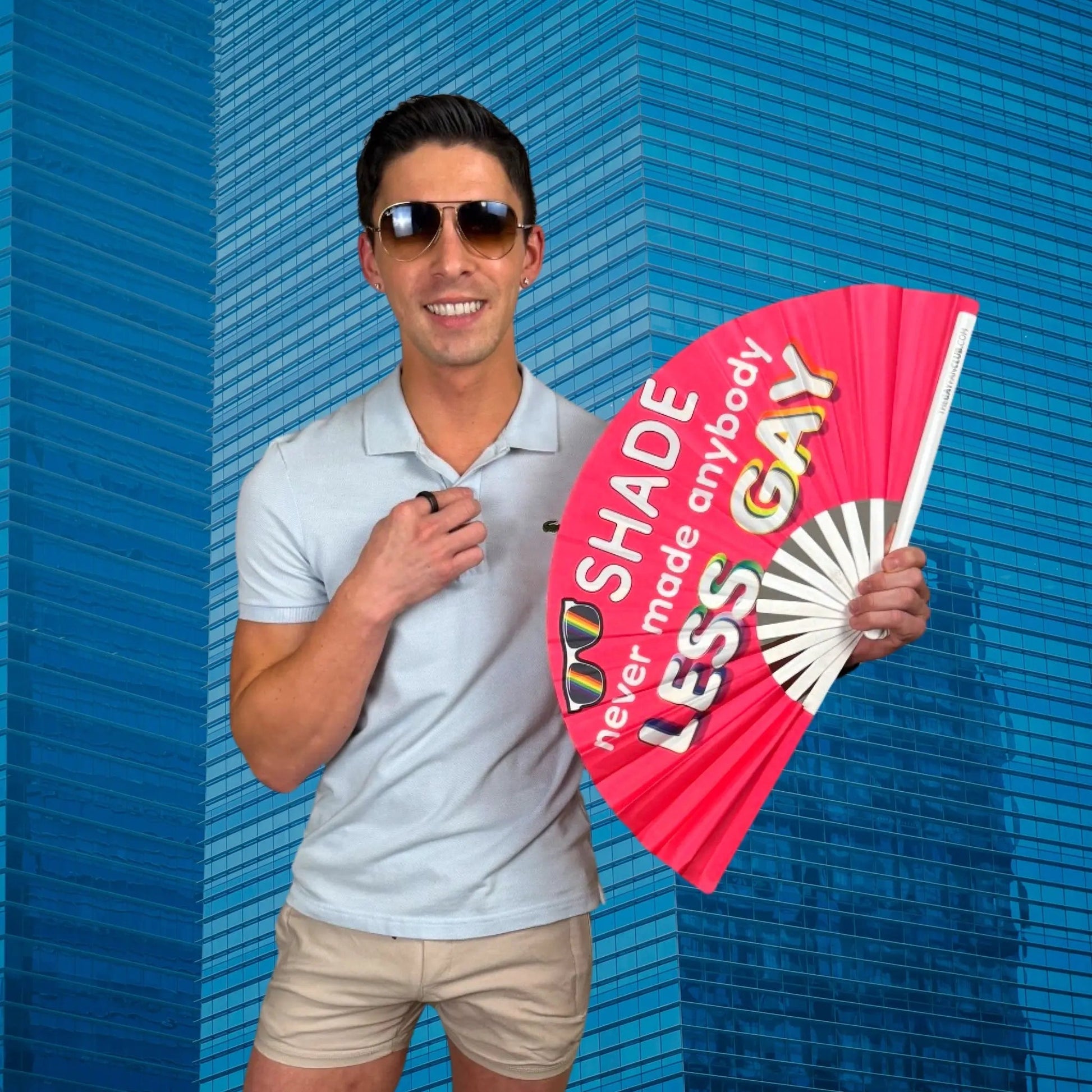 Hand fan from The Gay Fan Club with the phrase "Shade Never Made Anybody Less Gay" printed on it.