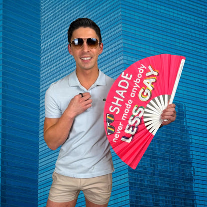 Hand fan from The Gay Fan Club with the phrase "Shade Never Made Anybody Less Gay" printed on it.