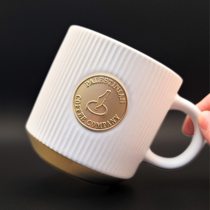 Black ceramic mug from Pali Coffee Co by The Palestinian Coffee Company, featuring a simple, stylish design for coffee lovers.