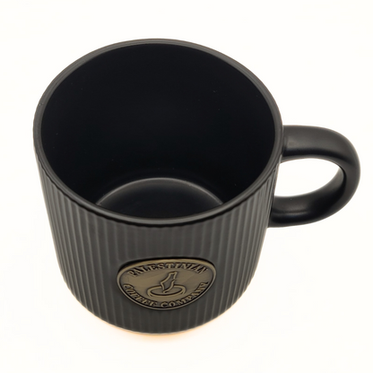 Black ceramic mug from Pali Coffee Co by The Palestinian Coffee Company, featuring the brand's logo and design.