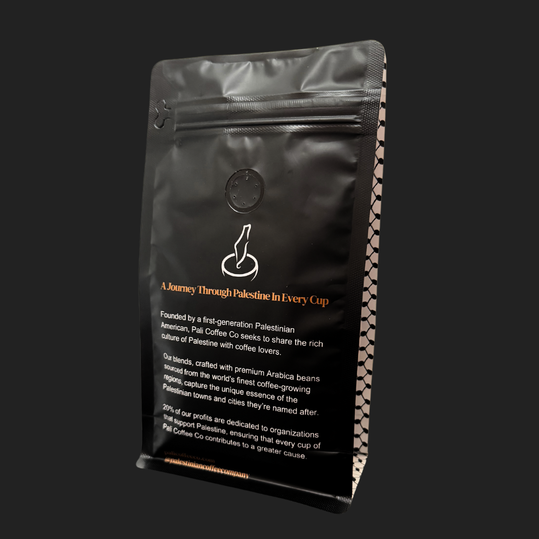 Ground Akka Blend Crème Caramel coffee by The Palestinian Coffee Company in a clear bag, showcasing rich, aromatic coffee grounds.