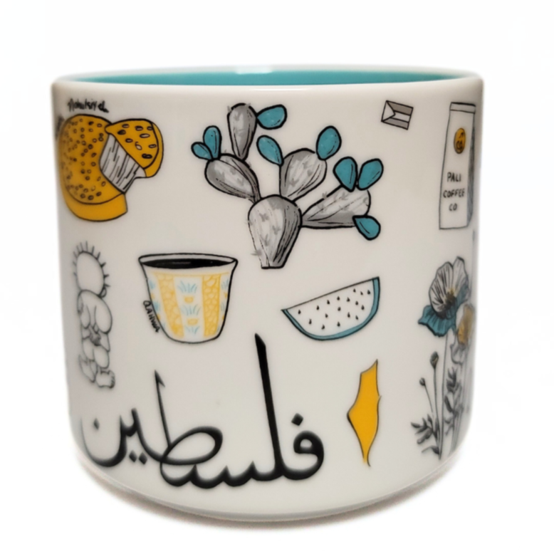 Palestine Mug by The Palestinian Coffee Company featuring traditional design and bold text on white ceramic mug.