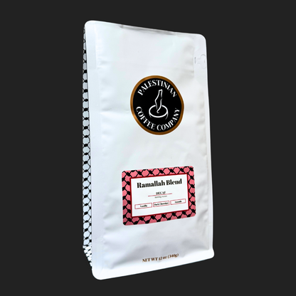 Whole beans of Ramallah Blend Decaf coffee by The Palestinian Coffee Company, showcasing rich, roasted coffee beans in a clear bag.