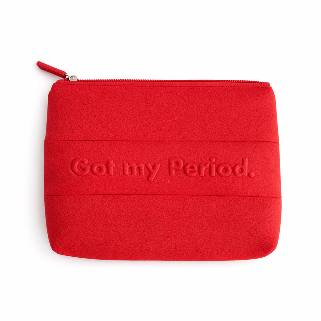 Red The Period Company pouch with The Period logo, made of soft fabric, designed for storing menstrual products and accessories.
