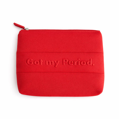 Red The Period Company pouch with The Period logo, made of soft fabric, designed for storing menstrual products and accessories.