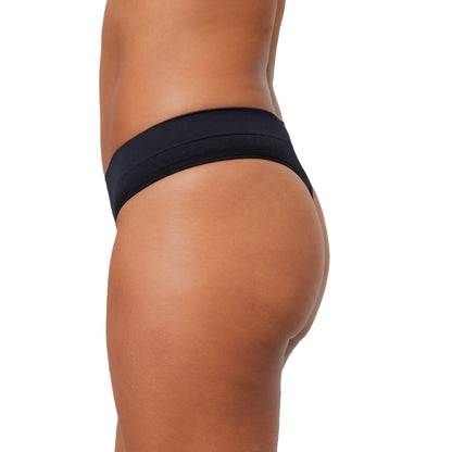 Light flow thong pad from The Period Company in SportyStretch™ fabric, shown on a model with a sleek, comfortable fit.