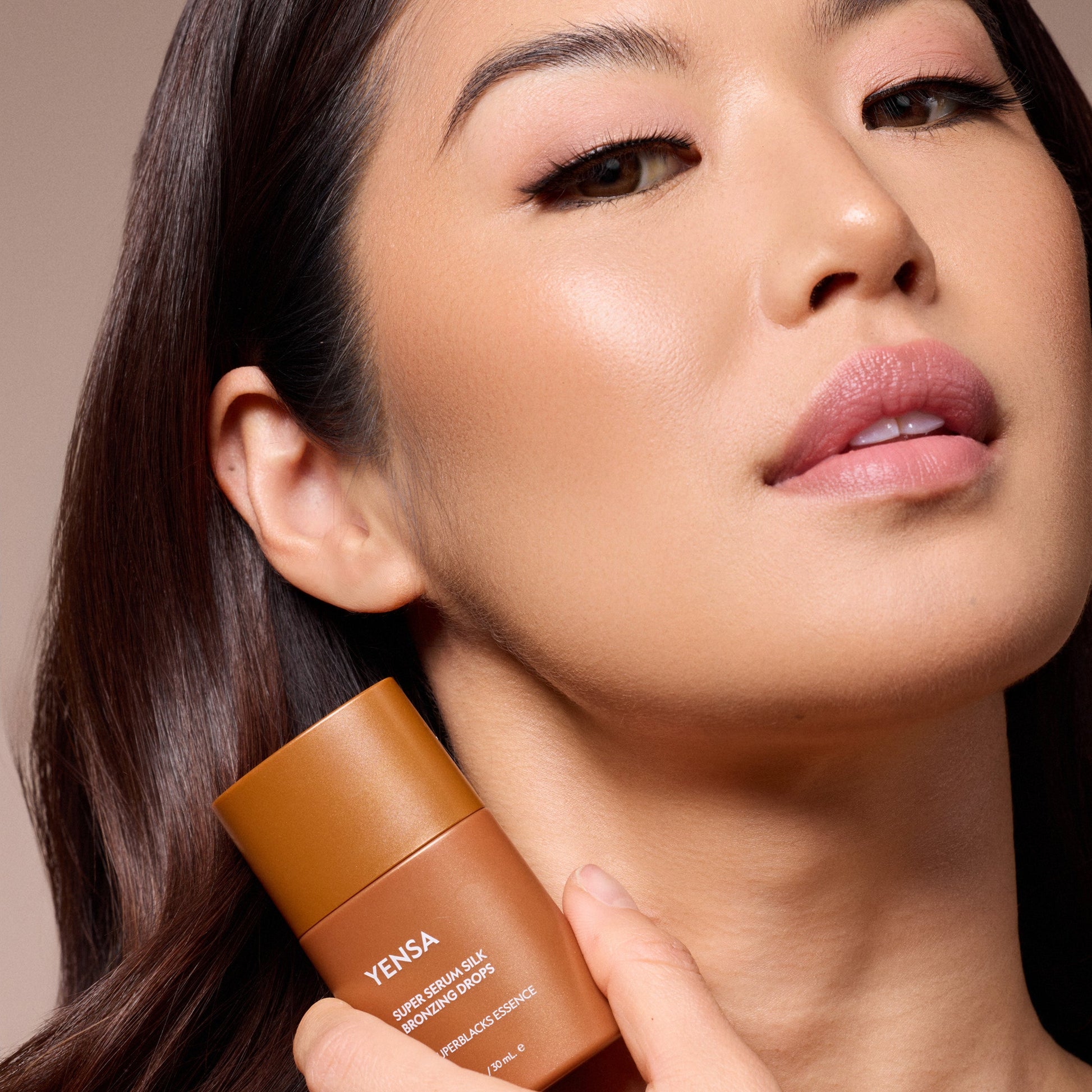 YENSA Super Serum Silk Bronzing Drops in a clear glass bottle with a dropper, showcasing the bronzer product.