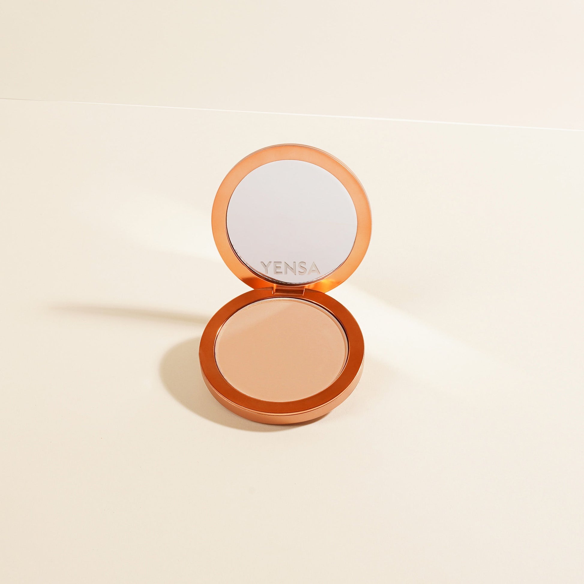 YENSA Super Serum Silk Matte Powder Peptide Foundation in fair shade, close-up of smooth, matte finish compact with foundation inside.