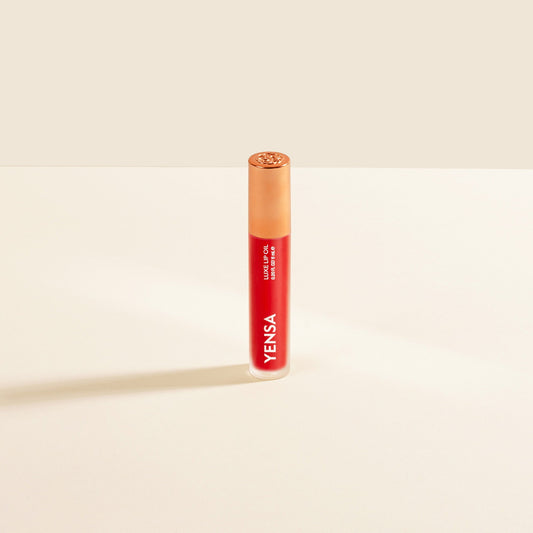 YENSA Luxe Lip Nourishing Oil with hyaluronic and vitamin E, featuring a vibrant red lip gloss tube and a glossy finish.