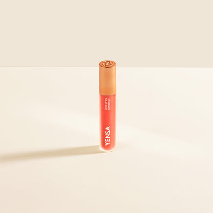 YENSA Luxe Lip Nourishing Oil with Hyaluronic and Vitamin E, showing the sleek lip oil bottle with a ruby-colored tint.