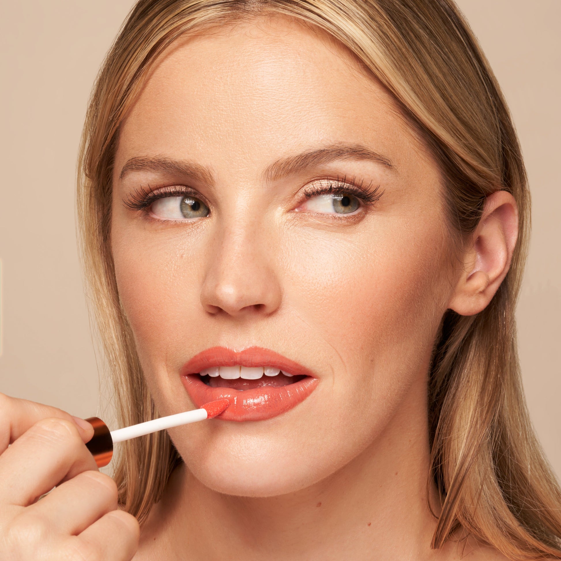 YENSA Luxe Lip Nourishing Oil with Hyaluronic and Vitamin E, showing a sleek lip oil bottle with a shiny metallic cap and clear branding.