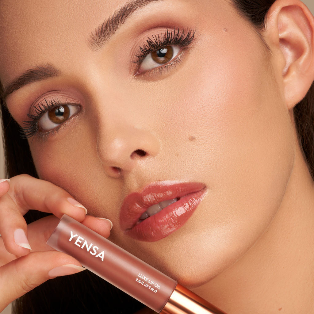 YENSA Luxe Lip Nourishing Oil with Hyaluronic and Vitamin E, displaying a sleek lip oil bottle with a clear applicator.