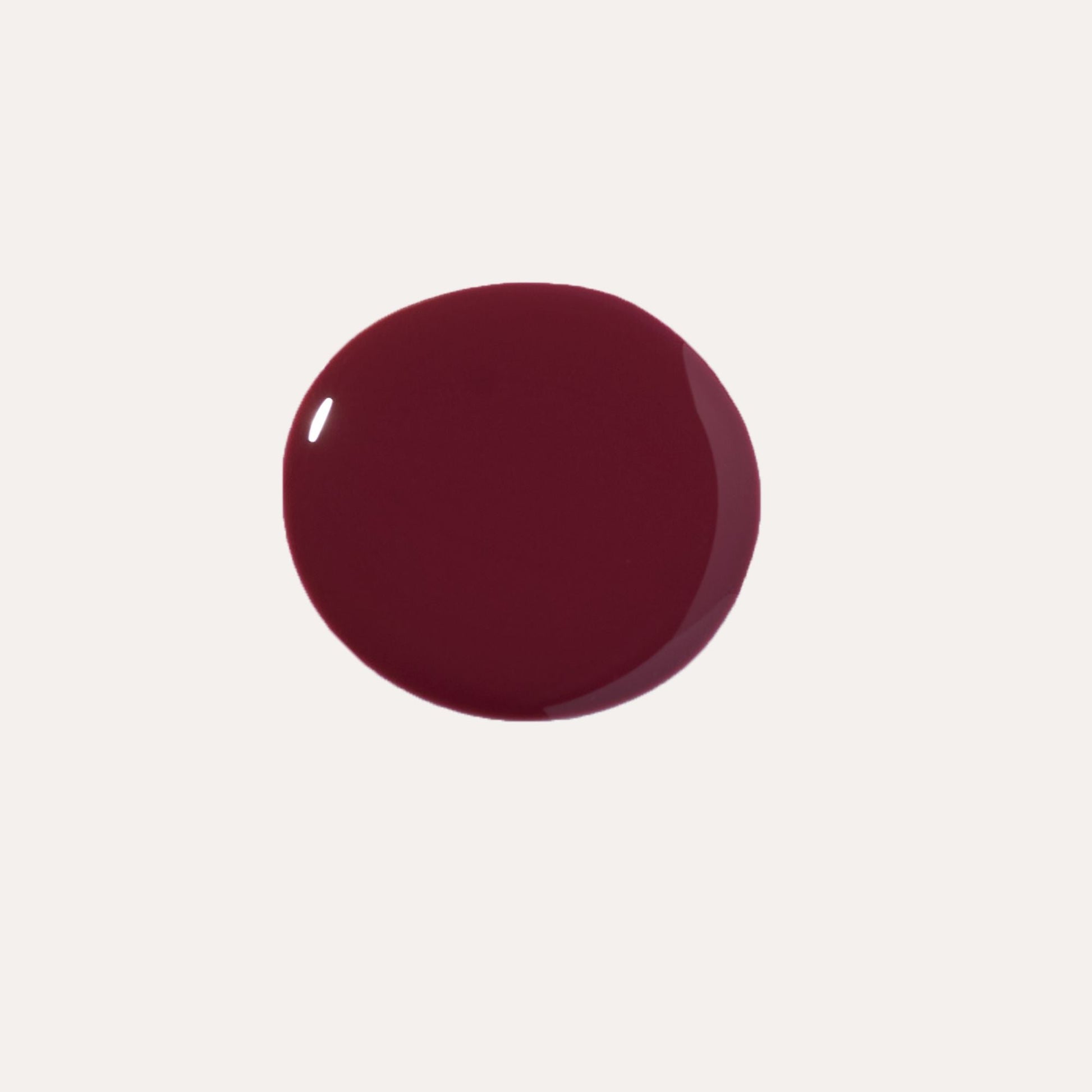 YENSA Luxe Lip Nourishing Oil in Rising Ruby, featuring a clear lip oil bottle with a gold cap and a ruby-red tint.