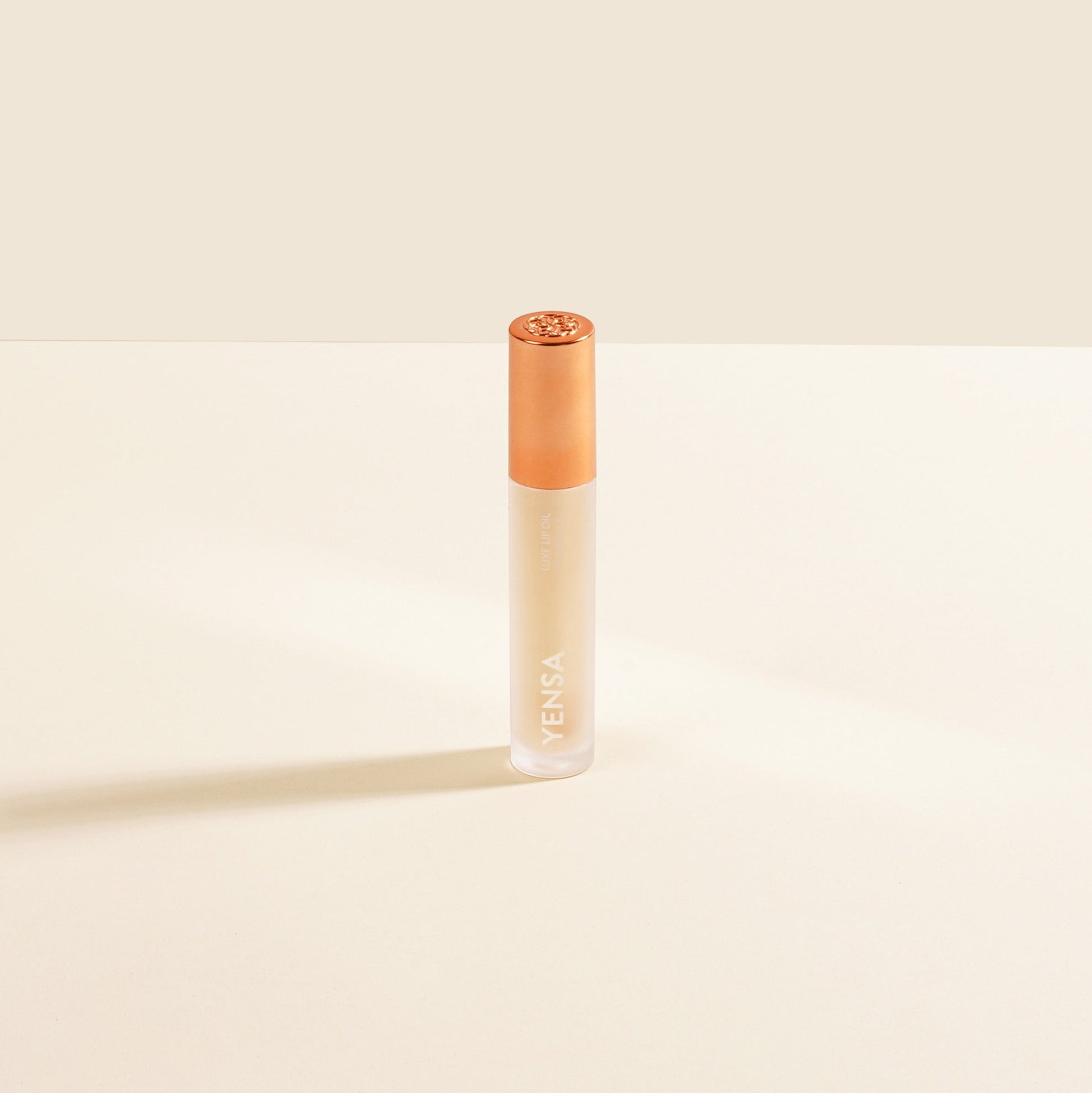YENSA Luxe Lip Nourishing Oil with Hyaluronic and Vitamin E, displaying a sleek lip oil bottle with a glossy finish.