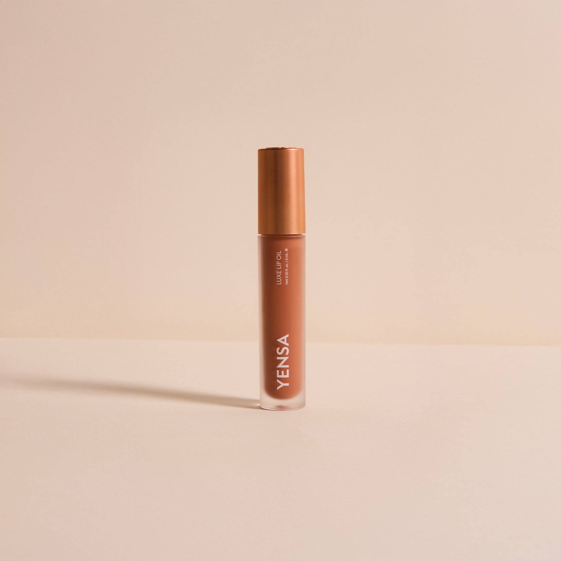 YENSA Luxe Lip Nourishing Oil with Hyaluronic and Vitamin E, displaying a sleek lip oil bottle with a clear, glossy finish.