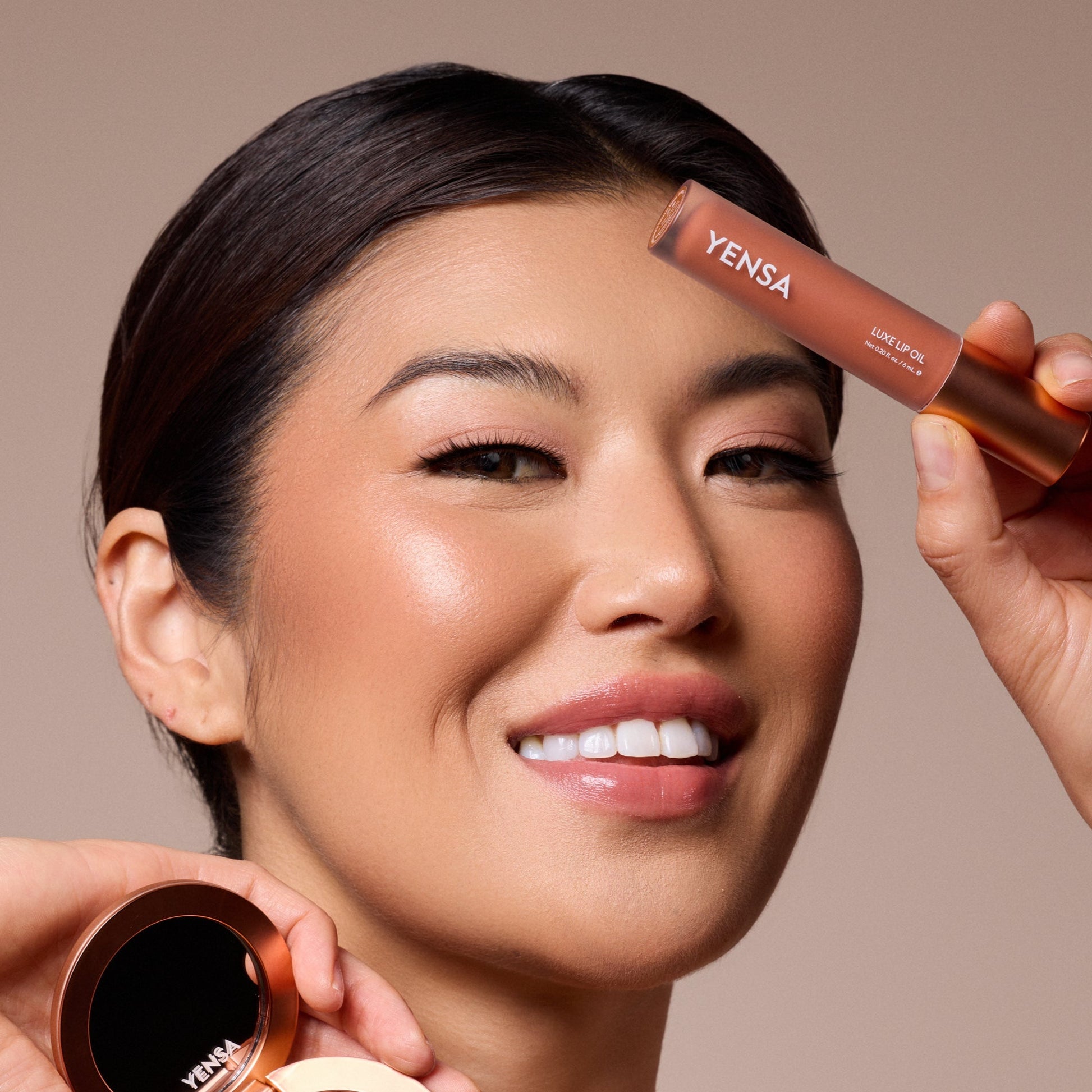 YENSA Luxe Lip Nourishing Oil with Hyaluronic and Vitamin E, clear glass bottle with red-tinted lip oil inside.